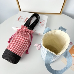 Detail of red and blue checkered water bottle bags with drawstring and denim base