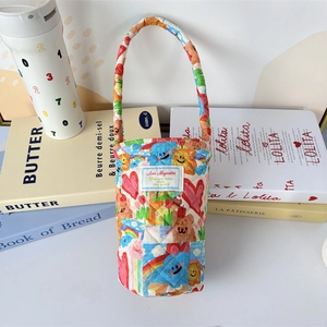 Close-up of quilted cotton water bottle carrier with colorful cartoon bear and rainbow prints