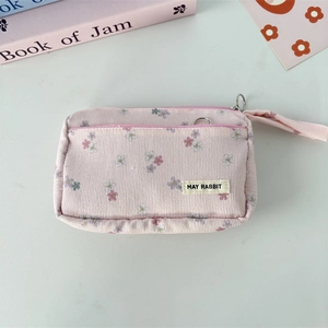 Detail of pink corduroy floral pencil case with zipper and May Rabbit brand label