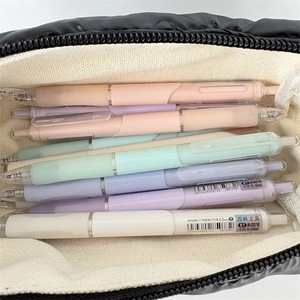 Detail of macaron gel pens in 0.5mm black ink inside a black quilted pencil case