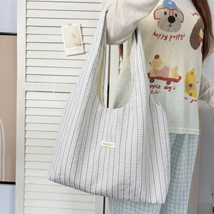 Minimalist rainbow stripe tote bag in grey and white canvas shown from a side view
