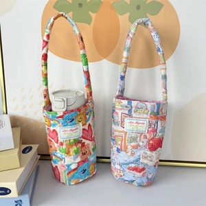 Close-up of quilted fabric cup sleeves with heart and rabbit illustration prints