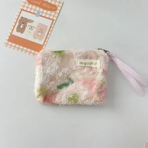 Detailed view of floral plush pouch with lace texture, mayrabbit label and pink ribbon zipper