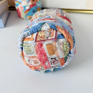 Detailed close-up of the quilted fabric texture and floral house print on the soft bag