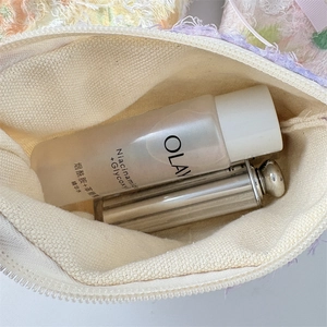 Internal view of a lavender lace cosmetic bag showing makeup storage capacity
