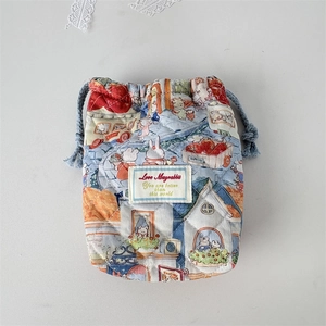 Detail of quilted drawstring camera pouch featuring cute rabbit prints and woven cords