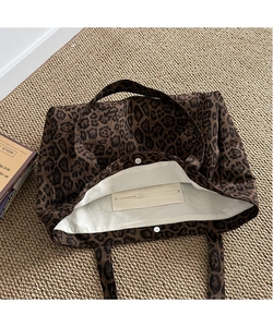 Detailed interior of leopard canvas tote featuring magnetic closure and zip pocket