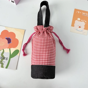 Detail of red checkered water bottle pouch with black base and drawstring closure