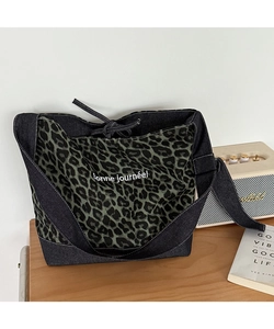 Detail of leopard print canvas and denim patchwork tote bag with Bonne journée text