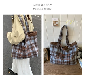 Detail of plaid tote bag featuring coffee-themed embroidery and brown corduroy trim