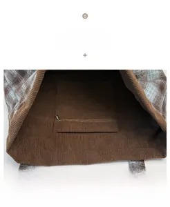 Detail of corduroy tote bag showing interior zippered pocket and plaid texture