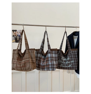 Detailed view of three vintage plaid tote bags featuring high-quality embroidered lettering