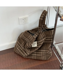 Close-up of brown plaid tote bag with vintage fabric texture and white YEYU BAG label