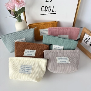 Corduroy makeup bags in multiple colors with zip closure and minimalist fabric label