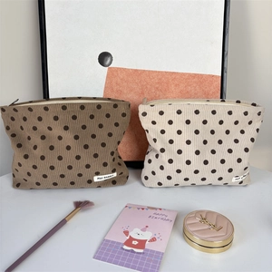 Corduroy polka dot cosmetic bags in dark brown and cream white with zipper and label