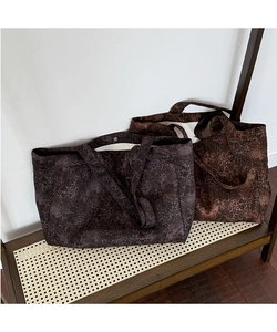 Detailed comparison of leopard and python print canvas tote bags in grey and tan tones