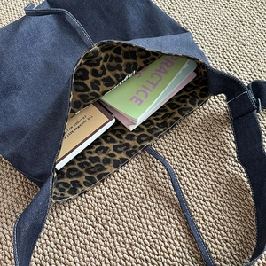 Deep blue denim tote bag with leopard print lining and contrast white stitching details