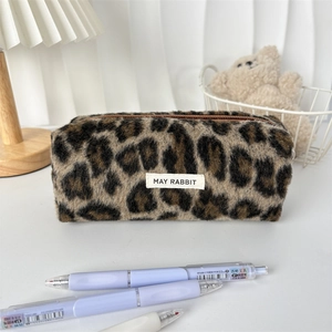 Close-up of leopard print plush pencil case with soft faux fur and May Rabbit label
