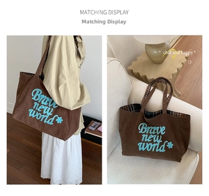 Brown corduroy tote bag with blue text and classic plaid lining interior detail