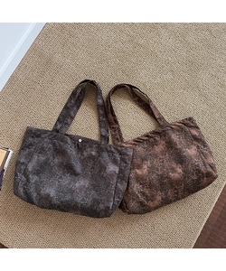 Detailed view of leopard print canvas tote bags with metal snap buttons and handles