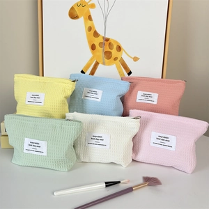 Portable waffle texture makeup pouches in six pastel colors with metal zipper closure