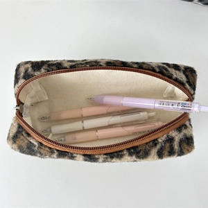 Internal view of plush leopard print pencil case showing beige canvas lining and capacity