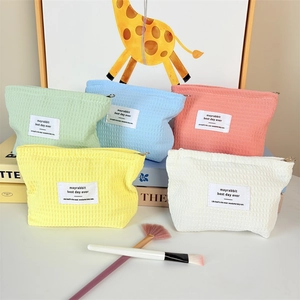 Set of five colorful waffle weave makeup bags in pastel tones for travel organization
