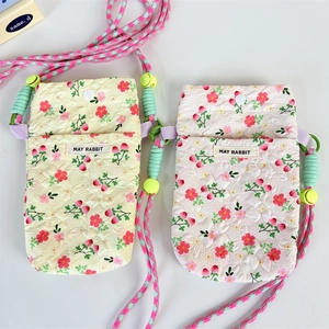 Floral quilted crossbody phone bags in yellow and white with adjustable rope straps