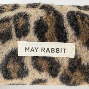 Macro shot of leopard print fabric texture and a sewn-on May Rabbit brand label