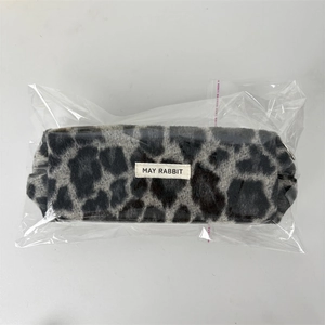 Detail of plush leopard print pencil case in transparent plastic packaging wrap