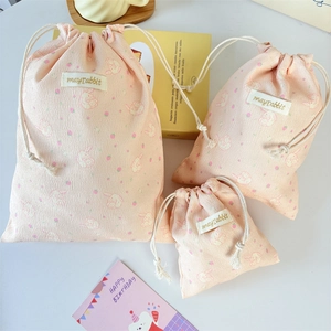 Three-piece pink corduroy drawstring bags with rabbit print and cotton rope closures