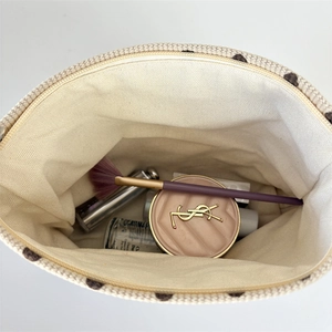 Top view of beige corduroy polka dot makeup bag showing spacious canvas interior