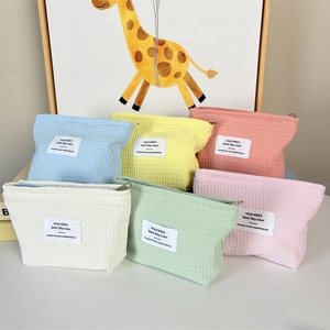 Flat lay of colorful waffle pattern makeup bags with minimalist metal zippers