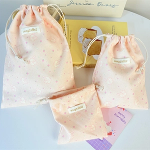 Three sizes of pink corduroy drawstring bags with rabbit prints and soft ribbed texture