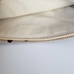 Detail shot of the durable woven fabric lining and smooth nylon zipper on a corduroy bag