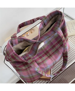 Detail of checkered wool tote bag showing handmade label and spacious interior lining
