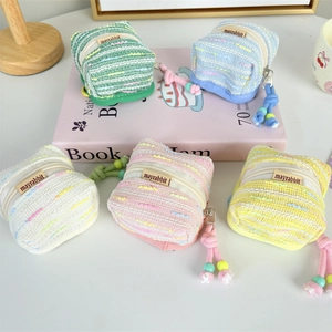 Detailed view of colorful woven tweed mini earphone pouches with decorative beaded zippers