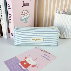 Close-up of pleated stripe stationery pouch featuring mayrabbit tag and metal zipper