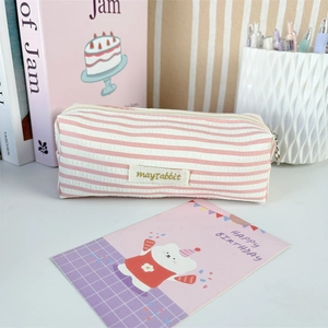 Close-up of pink and white striped fabric pencil case with mayrabbit label and zipper