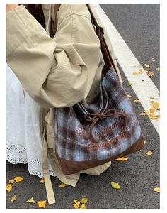 Detail of plaid canvas tote bag with bow tie embroidery and corduroy拼接 base