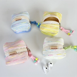 Mini macaron knit earbud pouches in pink, blue, yellow, and white with beaded lanyards