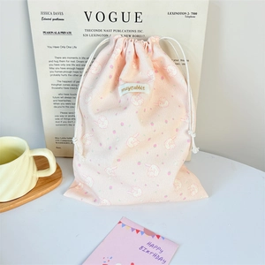 Detail of pink corduroy drawstring pouch featuring cute rabbit and strawberry prints