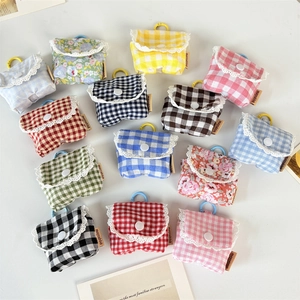 Floral and plaid fabric earphone pouches with lace trim and hanging hooks in various colors