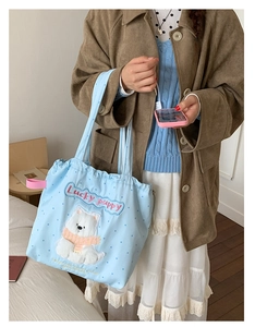 Close-up of cute light blue tote with 3D puppy embroidery and Lucky Puppy lettering