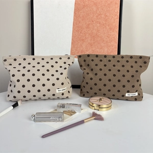 Detailed corduroy texture and polka dot pattern on travel makeup storage bags