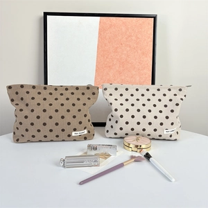Detailed view of vintage polka dot corduroy pouches with smooth metal zippers
