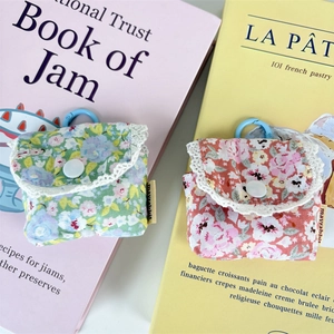 Detailed view of floral earbuds pouch with white lace trim and blue carabiner clip