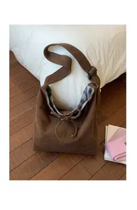 Detail of brown corduroy tote bag with Bonne journée embroidery and floral lining