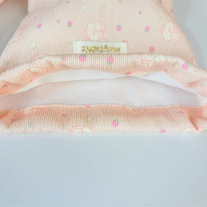 Detailed texture of pink corduroy pouch with cute strawberry and bunny pattern prints