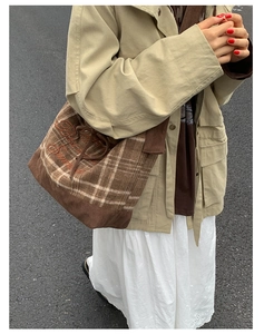 Detail of plaid canvas tote bag with embroidery, corduroy texture and drawstring closure